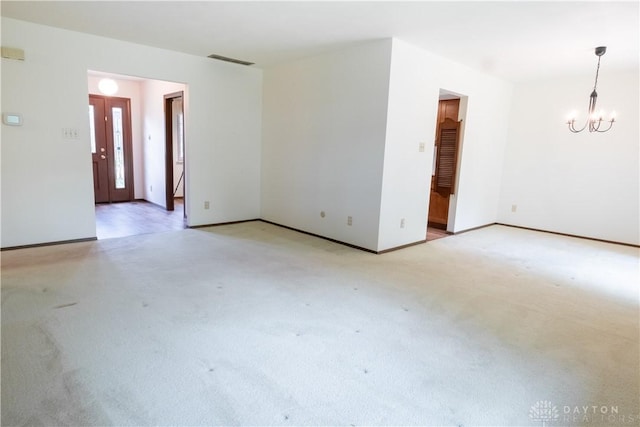 4425 E Entrada Dr, Beavercreek, OH 45431 - unfurnished room with a chandelier and light carpet