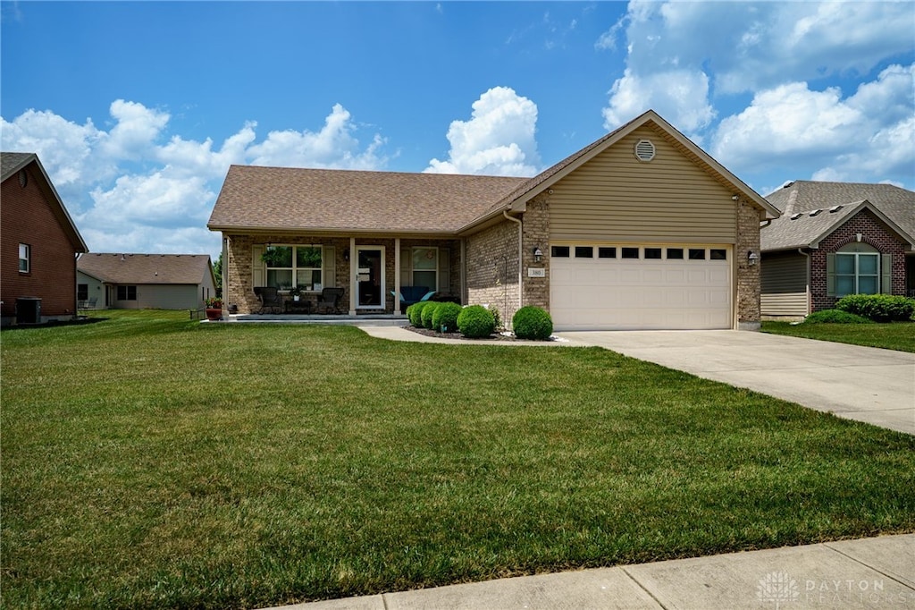 380 Clear Springs Ct, Franklin, OH 45005 - ranch-style home featuring concrete driveway, a garage, a front lawn, a porch, and brick siding