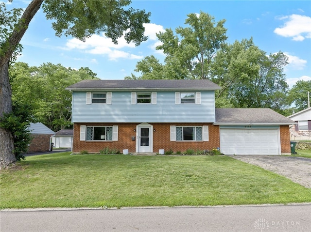 6118 Carnation Rd, Dayton, OH 45449 - colonial inspired home with a garage, asphalt driveway, a front lawn, and brick siding