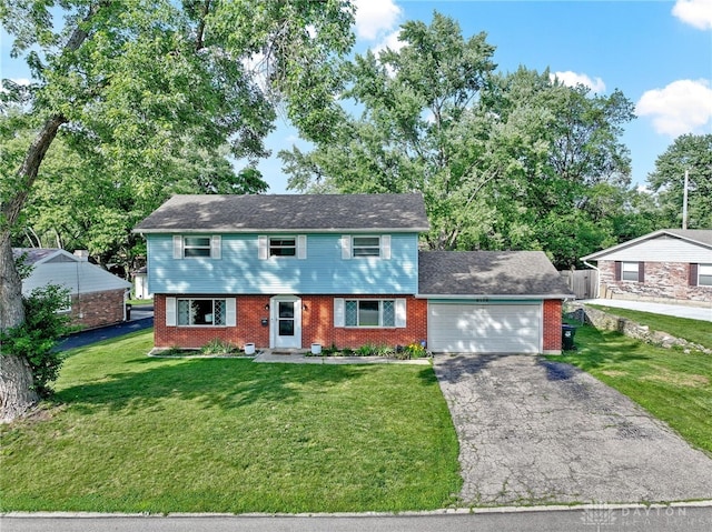6118 Carnation Rd, Dayton, OH 45449 - colonial-style house with an attached garage, asphalt driveway, and brick siding