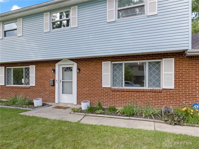 6118 Carnation Rd, Dayton, OH 45449 - view of front of home featuring brick siding and a front lawn