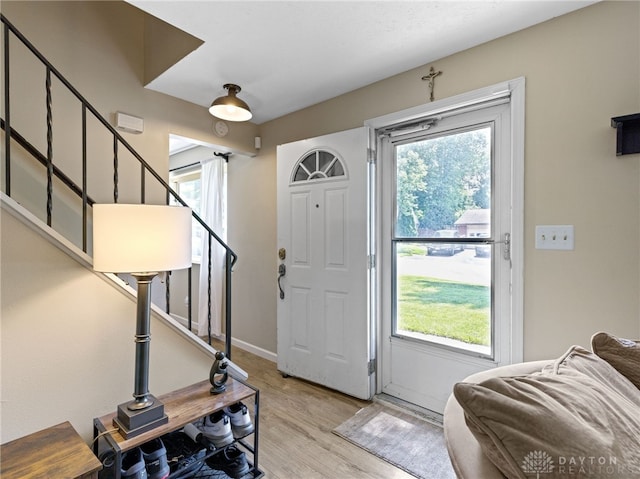 6118 Carnation Rd, Dayton, OH 45449 - foyer entrance featuring light wood-style flooring, stairs, and plenty of natural light