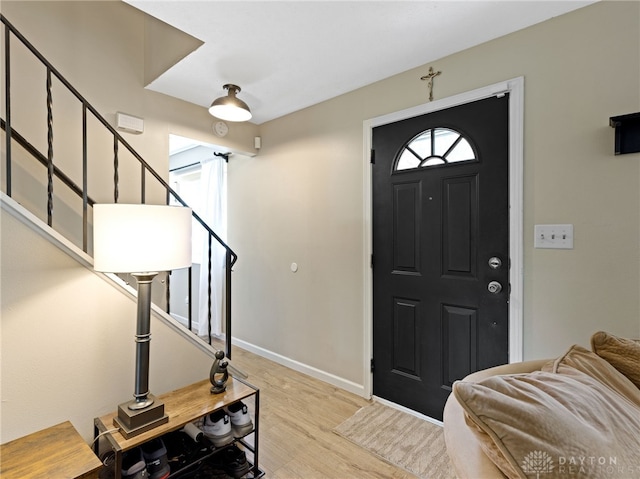 6118 Carnation Rd, Dayton, OH 45449 - foyer entrance featuring stairs, wood finished floors, and plenty of natural light