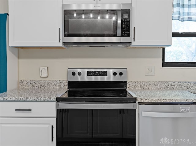 6118 Carnation Rd, Dayton, OH 45449 - kitchen featuring stainless steel appliances, white cabinets, and light stone counters
