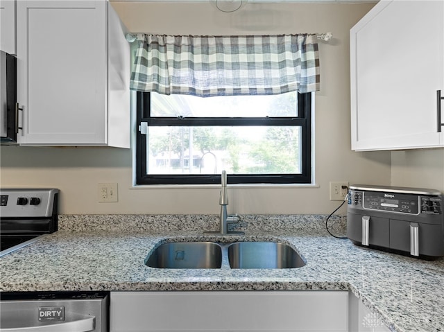 6118 Carnation Rd, Dayton, OH 45449 - kitchen featuring stainless steel appliances, white cabinets, and light stone countertops
