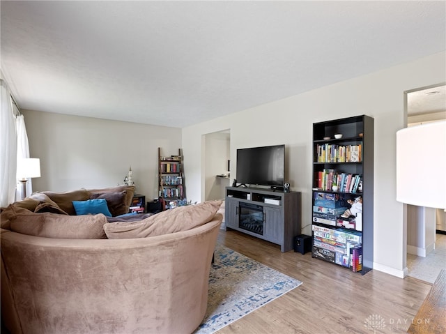 6118 Carnation Rd, Dayton, OH 45449 - living area with a glass covered fireplace and wood finished floors