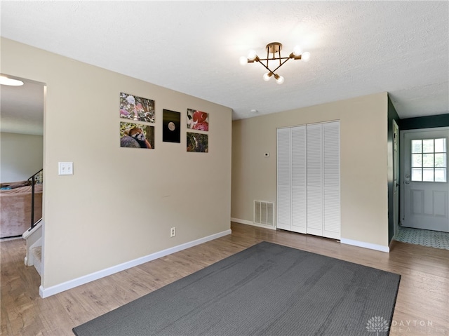 6118 Carnation Rd, Dayton, OH 45449 - interior space featuring wood finished floors, a closet, and a chandelier