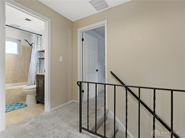 6118 Carnation Rd, Dayton, OH 45449 - staircase with carpet floors and tile patterned floors