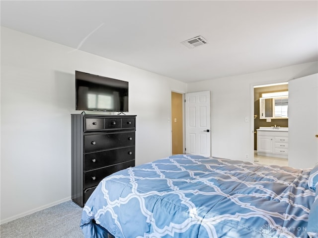 6118 Carnation Rd, Dayton, OH 45449 - bedroom with light colored carpet and ensuite bath