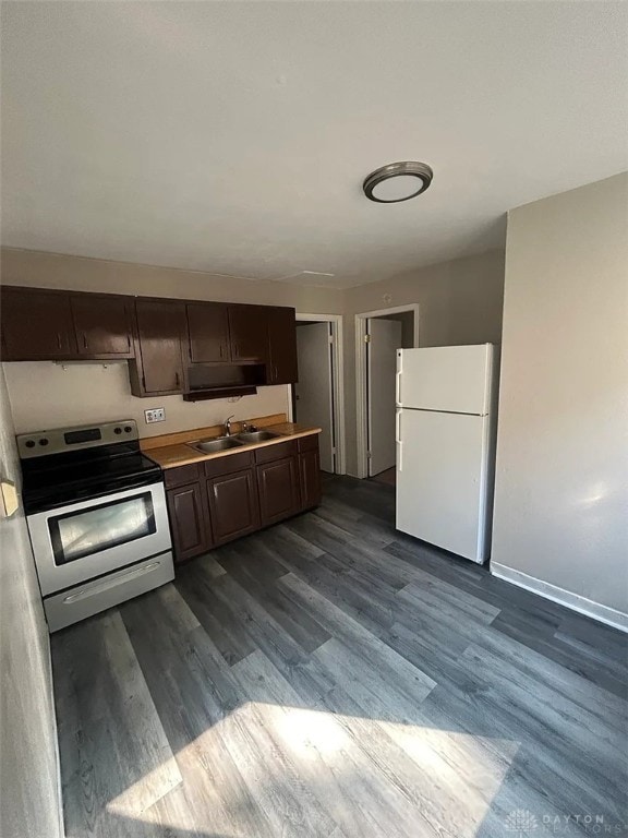 4129 E 3rd St Unit 4127, Dayton, OH 45403 - kitchen with freestanding refrigerator, stainless steel range with electric cooktop, dark brown cabinets, dark wood finished floors, and light countertops