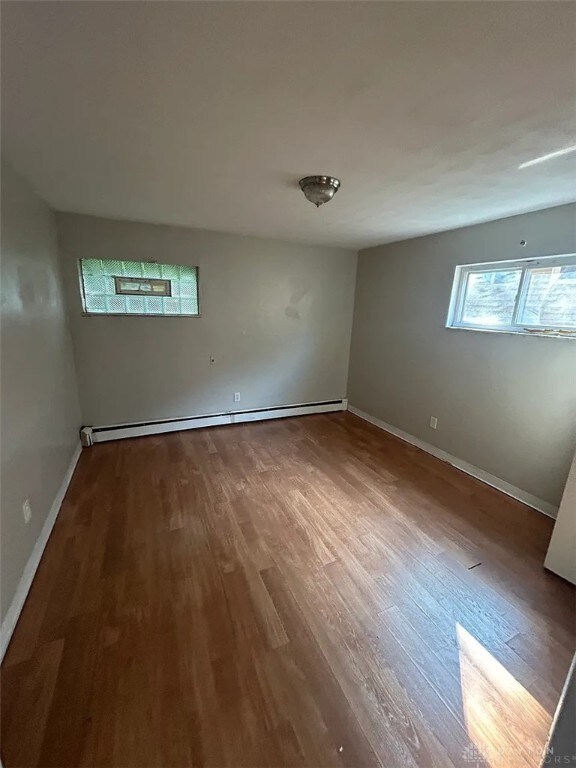4129 E 3rd St Unit 4127, Dayton, OH 45403 - spare room with baseboard heating and wood finished floors