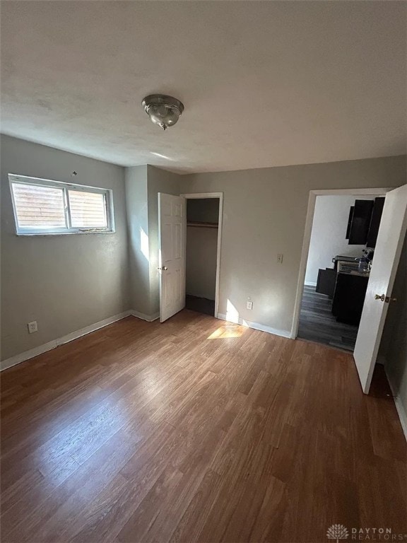 4129 E 3rd St Unit 4127, Dayton, OH 45403 - unfurnished bedroom featuring wood finished floors and a closet