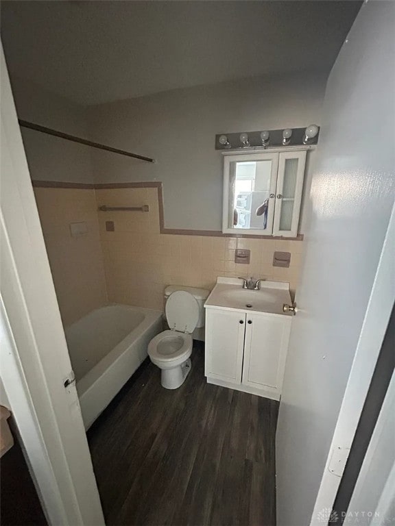 4129 E 3rd St Unit 4127, Dayton, OH 45403 - bathroom with vanity, wood finished floors, tile walls, and washtub / shower combination