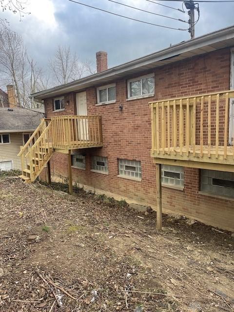 4129 E 3rd St Unit 4127, Dayton, OH 45403 - back of property with a chimney, brick siding, and stairs