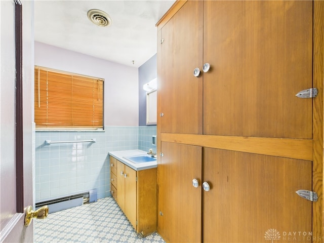 2120 Wyoming St, Dayton, OH 45410 - bathroom with vanity, tile walls, a wainscoted wall, and baseboard heating