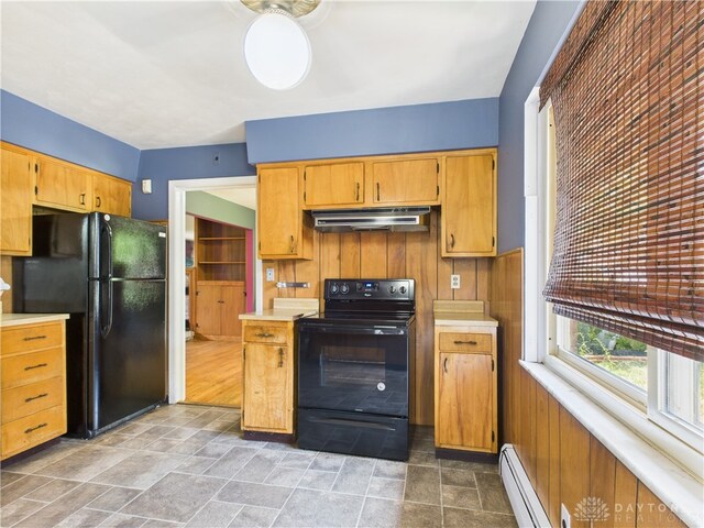 2120 Wyoming St, Dayton, OH 45410 - kitchen with black appliances, baseboard heating, under cabinet range hood, and stone finish flooring
