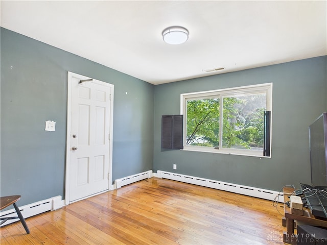 2120 Wyoming St, Dayton, OH 45410 - spare room with a baseboard radiator and hardwood / wood-style flooring