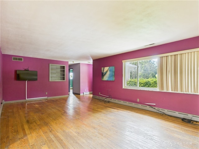 2120 Wyoming St, Dayton, OH 45410 - unfurnished living room featuring hardwood / wood-style floors, a baseboard radiator, and a baseboard heating unit