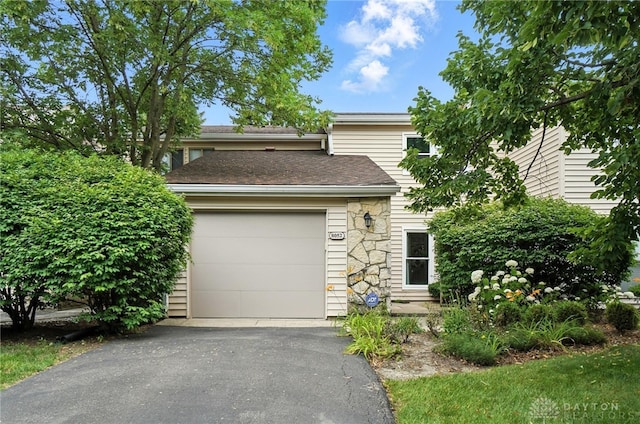 8052 Timberlodge Trl, Washington Twp, OH 45458 - view of front of home featuring asphalt driveway, an attached garage, and stone siding