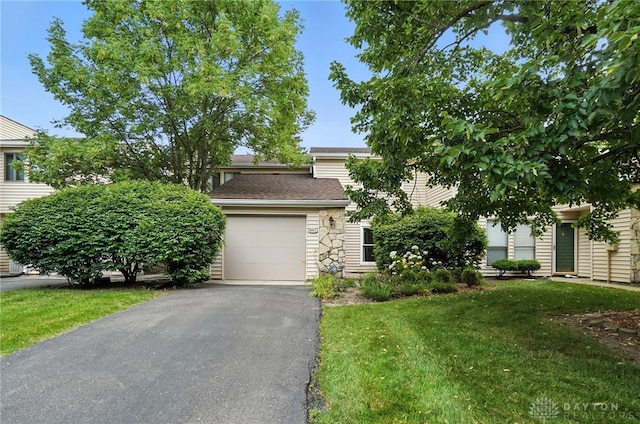 8052 Timberlodge Trl, Washington Twp, OH 45458 - view of property hidden behind natural elements featuring driveway, a garage, a front yard, and a shingled roof