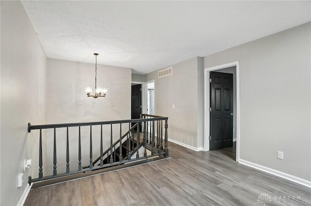 8052 Timberlodge Trl, Washington Twp, OH 45458 - empty room featuring wood finished floors and a chandelier