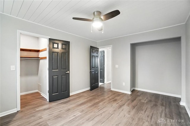 8052 Timberlodge Trl, Washington Twp, OH 45458 - unfurnished bedroom featuring wood finished floors, a closet, a walk in closet, ceiling fan, and ornamental molding