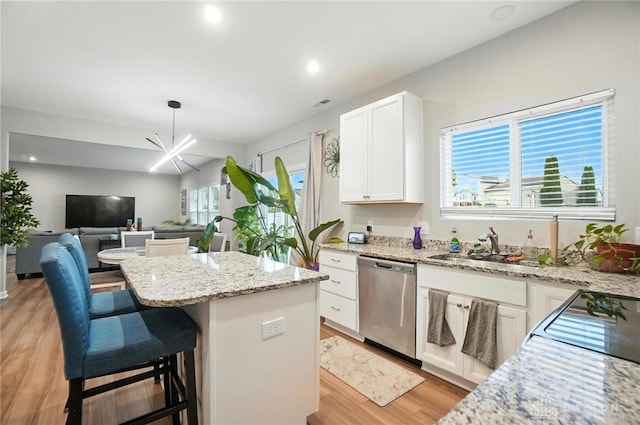 166 Brooke Parke Ave, Brookville, OH 45309 - kitchen featuring dishwasher, a center island, light wood-style flooring, white cabinets, and light stone countertops