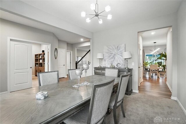 166 Brooke Parke Ave, Brookville, OH 45309 - carpeted dining space with a chandelier and stairway