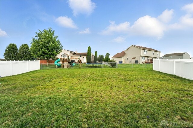 166 Brooke Parke Ave, Brookville, OH 45309 - fenced backyard featuring a playground and a trampoline