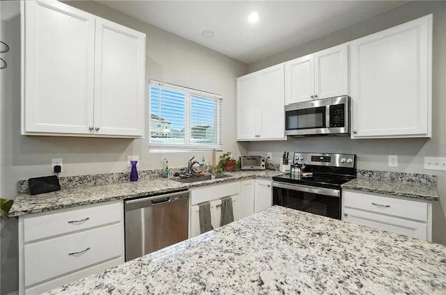 166 Brooke Parke Ave, Brookville, OH 45309 - kitchen with appliances with stainless steel finishes, white cabinets, and light stone counters