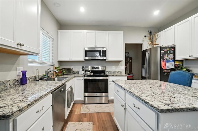 166 Brooke Parke Ave, Brookville, OH 45309 - kitchen with stainless steel appliances, light wood-type flooring, white cabinetry, light stone countertops, and recessed lighting