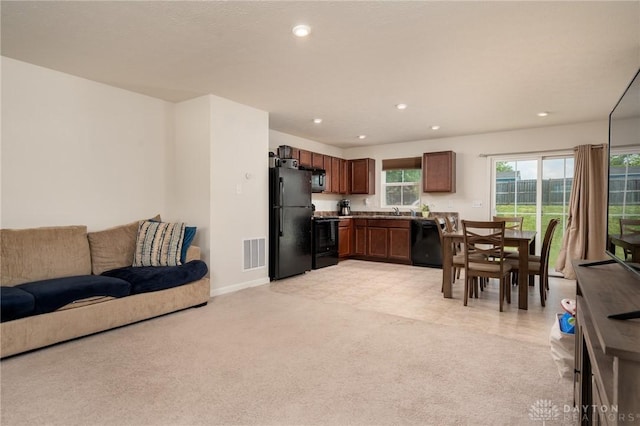 1009 Glen Kegley Dr, Xenia, OH 45385 - kitchen with black appliances, open floor plan, recessed lighting, and light colored carpet