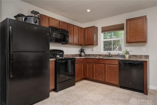 1009 Glen Kegley Dr, Xenia, OH 45385 - kitchen featuring black appliances, dark countertops, and brown cabinetry