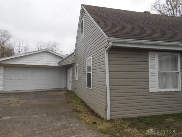 1930 Emerald Ct, Dayton, OH 45403 - view of property exterior featuring a shingled roof, driveway, and a garage