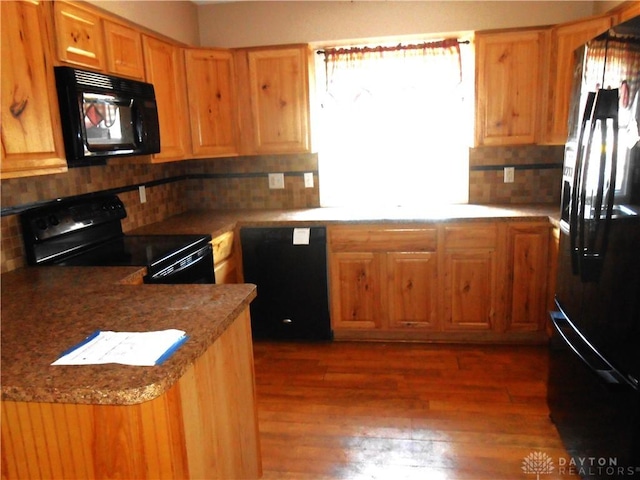 1930 Emerald Ct, Dayton, OH 45403 - kitchen featuring black appliances, tasteful backsplash, and wood finished floors
