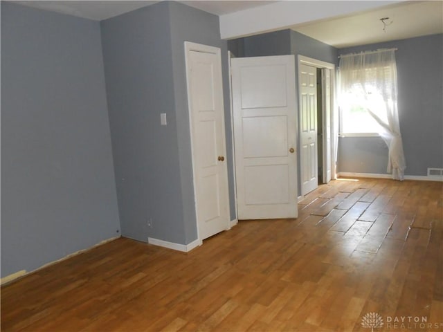 1930 Emerald Ct, Dayton, OH 45403 - spare room featuring wood finished floors and baseboards