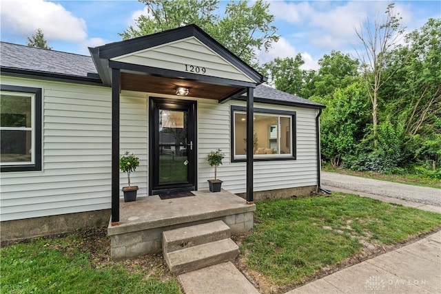 1209 Maple St, Troy, OH 45373 - view of front of property with roof with shingles and a front yard