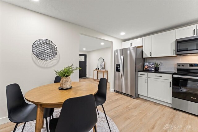 1209 Maple St, Troy, OH 45373 - kitchen featuring stainless steel appliances, light wood finished floors, white cabinets, and recessed lighting