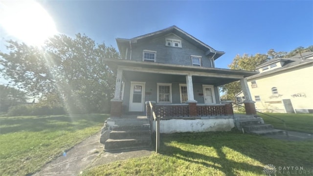 16 E Hudson Ave Unit 14, Dayton, OH 45405 - view of front facade with a porch and a front lawn