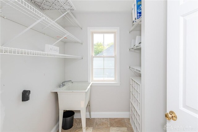 1129 Eureka Dr, Kettering, OH 45419 - laundry room with baseboards and a sink