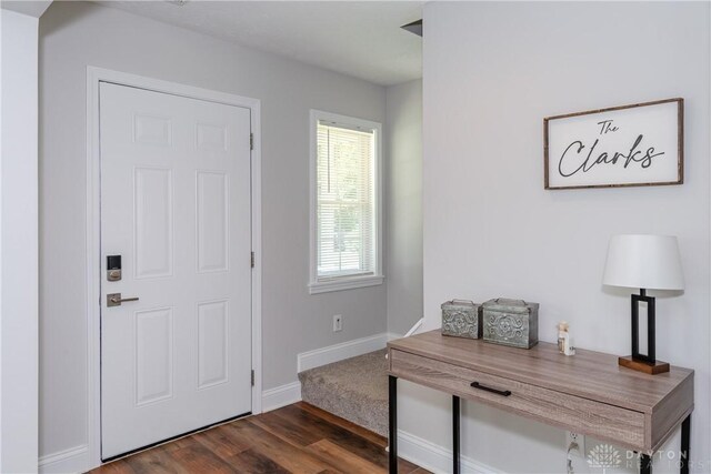 1129 Eureka Dr, Kettering, OH 45419 - foyer entrance with dark wood-type flooring and baseboards