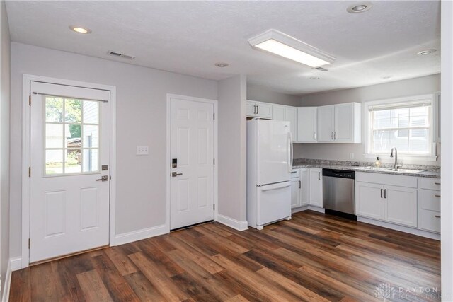 1129 Eureka Dr, Kettering, OH 45419 - kitchen with freestanding refrigerator, dishwasher, dark wood-type flooring, recessed lighting, and white cabinetry