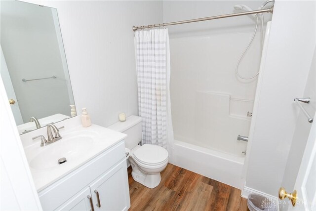 1129 Eureka Dr, Kettering, OH 45419 - bathroom featuring vanity, wood finished floors, and shower / bathtub combination with curtain