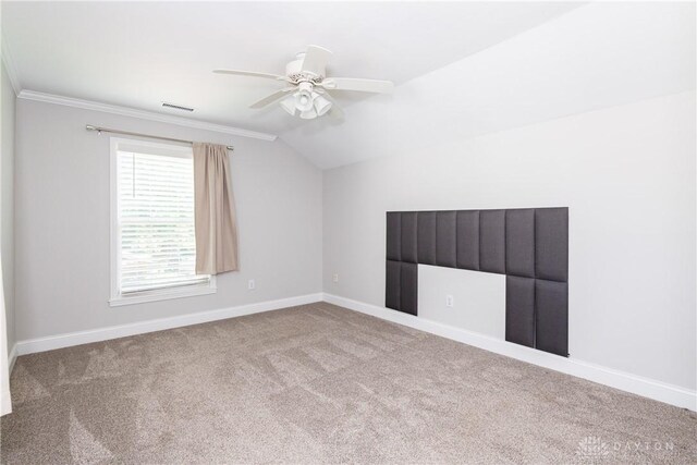 1129 Eureka Dr, Kettering, OH 45419 - empty room featuring carpet flooring, lofted ceiling, a ceiling fan, and ornamental molding