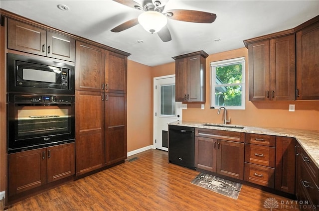 118 Hill St, Xenia, OH 45385 - kitchen featuring black appliances, dark wood-style floors, a ceiling fan, and light stone counters