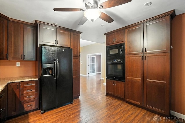 118 Hill St, Xenia, OH 45385 - kitchen with black appliances, dark wood-style flooring, a ceiling fan, light stone countertops, and dark brown cabinetry
