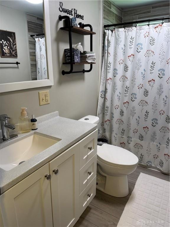 6346 Apache St, Dayton, OH 45424 - bathroom featuring vanity, wood finished floors, and a shower with shower curtain