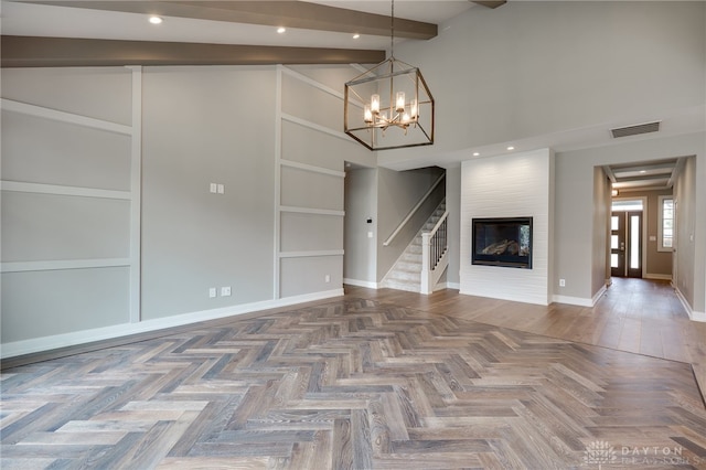 1461 Abbey Park Pl, Beavercreek Twp, OH 45385 - unfurnished living room featuring built in shelves, stairs, a high ceiling, a chandelier, and a fireplace