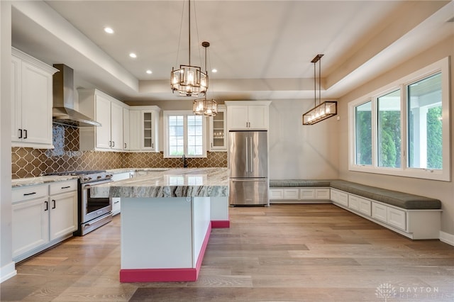 1461 Abbey Park Pl, Beavercreek Twp, OH 45385 - kitchen with stainless steel appliances, wall chimney range hood, glass insert cabinets, light wood-type flooring, and recessed lighting