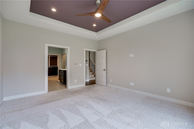 1461 Abbey Park Pl, Beavercreek Twp, OH 45385 - unfurnished bedroom with light carpet, a raised ceiling, recessed lighting, and ensuite bath